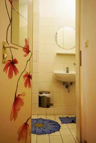 a small bathroom with a sink and a mirror at Zimmerfrei-Wuerzburg Stadtmitte in Würzburg