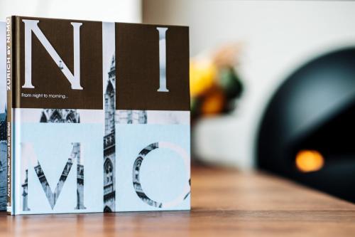 a book sitting on top of a wooden table at Boutique Hotel NI-MO in Zürich