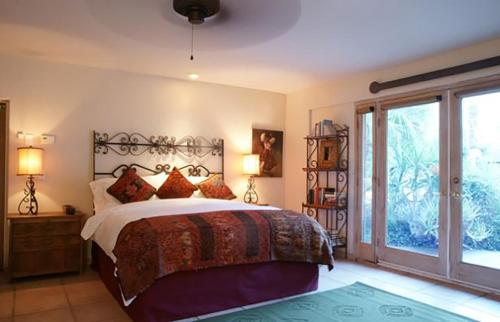 a bedroom with a large bed and a large window at Villa Thornhill in Palm Springs