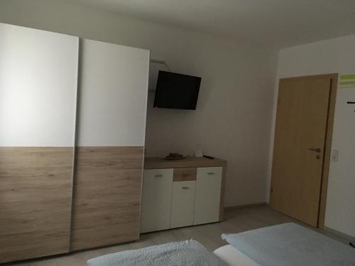 a living room with a tv and a cabinet at Ferienwohnung Wittenburg in Hermagor