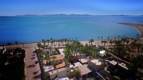 an aerial view of a beach and the ocean at Sukasa Bungalows in Loreto