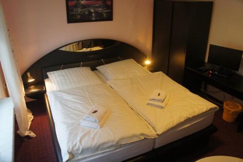 a bedroom with a bed with two towels on it at Corso in Bad Wilsnack