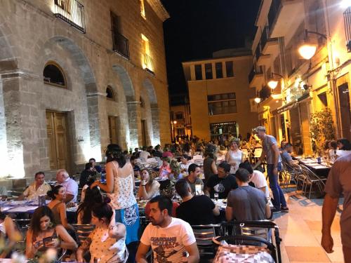 a group of people sitting at tables in a building at No3 CasaTosca Javea -Apart muy acogedor en el centro del Casco Antiguo in Jávea
