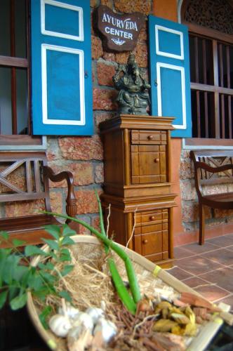 a model of a building with a bench and a dresser at Sandali Walauwa in Bentota
