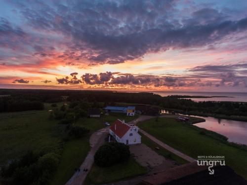 an aerial view of a house with a sunset in the background at Ungru Guesthouse in Suuresadama