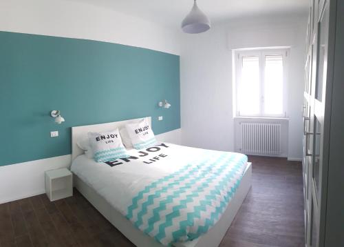 a bedroom with a large bed with a blue wall at Penthouse Salento - Galatina in Galatina
