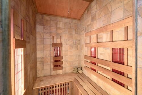 a sauna with wood paneled walls and windows at Ferienhaus Kreischberg - Silberhirschen Hütte in Sankt Lorenzen ob Murau