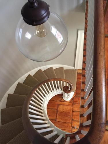 a spiral staircase with aendant light and a stair case at The Sailmaker's House in Portsmouth
