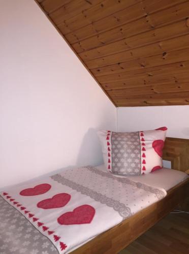 a bed in a room with red hearts on it at Ferienhaus am Silbersee Leni in Frielendorf