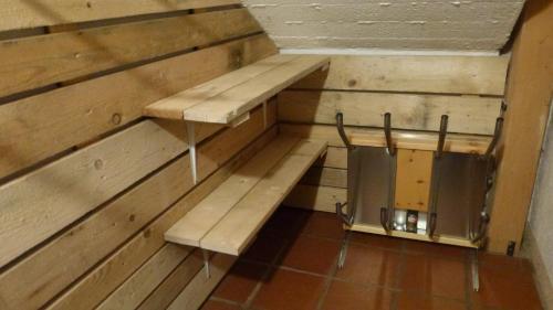 a room with two benches in a wooden wall at Alpenblick FeWo Hauser in Reisach
