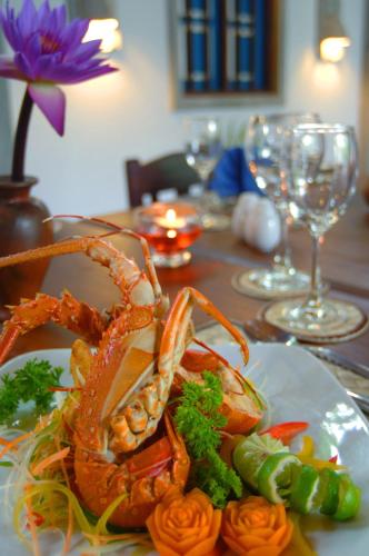 a plate of food with a lobster on a table at Sandali Walauwa in Bentota