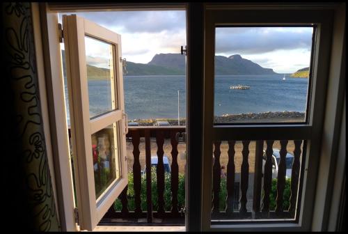 a view of the ocean from a balcony at Hótel Djúpavík in Djupavik