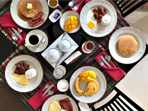 a table with plates of breakfast food on it at Jinjiang Inn - Boracay Station 1 in Boracay