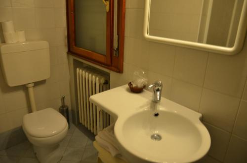 a bathroom with a white sink and a toilet at Hotel Arcella in Padova