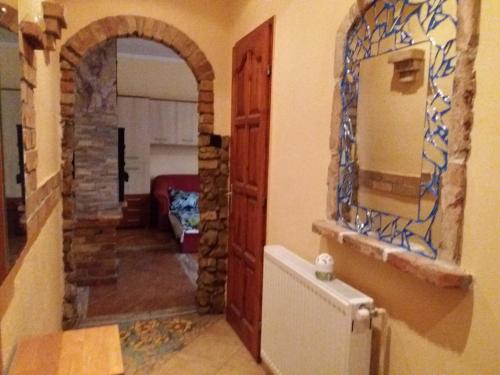 a room with a hallway with a door and a mirror at Kamilla Apartman in Esztergom