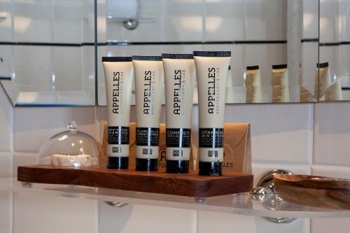 a group of four bottles of mascara on a shelf at Hydro Majestic Blue Mountains in Medlow Bath