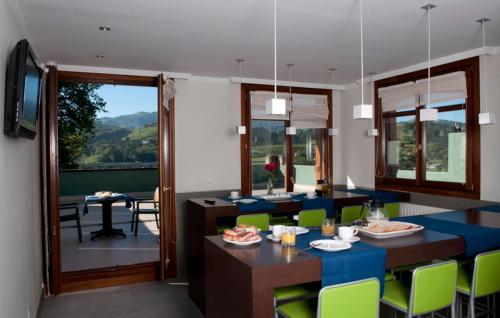 a living room with a table and chairs and a dining room at Apartamentos Turisticos Talaimendi in Zarautz