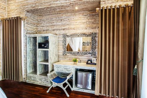 a room with a desk with a mirror and a chair at The Palm Grove Villas in Nusa Lembongan