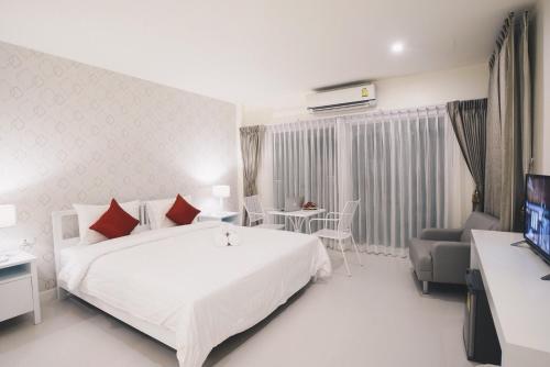 Кровать или кровати в номере Shunli Hotel - SHA Extra Plus