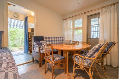 a room with a table and chairs and a bed at Oak House in Naantali