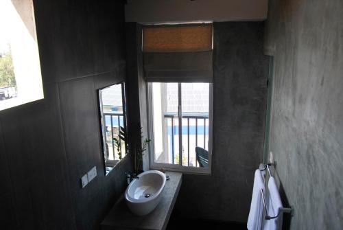 a bathroom with a sink and a mirror at The Canoe in Negombo