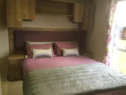 a bed with two pillows in a bedroom at Tattershall lakes in Tattershall