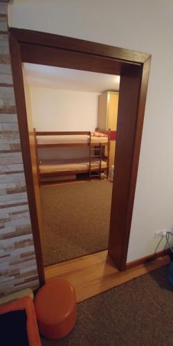 a mirror reflecting a room with a bed in a room at Lux - Apartment Snow Oasis in Vlasic