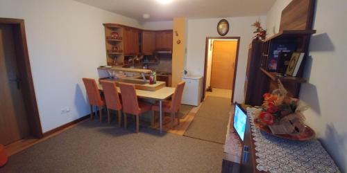a kitchen and dining room with a table and chairs at Lux - Apartment Snow Oasis in Vlasic