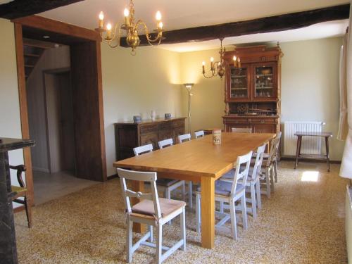 a dining room with a wooden table and chairs at Le Relais de la Houille in Sart-Custinne