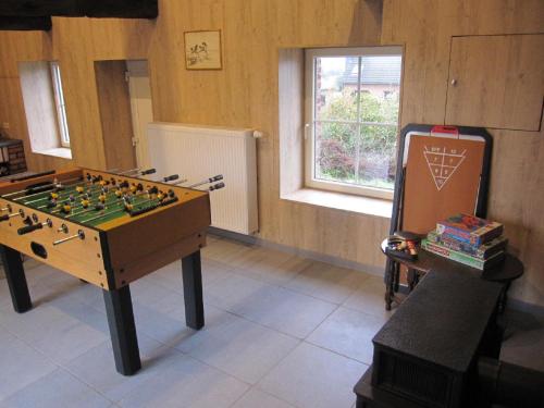 a room with a foosball table and a window at Le Relais de la Houille in Sart-Custinne