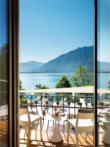 a balcony with a view of the water at Giardino Lago in Locarno