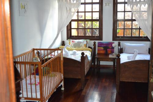 a room with two cribs and a room with windows at Sweet Home in Playa Honda