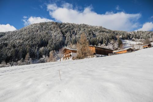 a snow covered mountain with a ski lodge in the background at Ladestatthof in Neustift im Stubaital