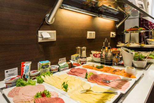 a buffet with many different types of meats and cheese at Hotel Esplanade Dortmund in Dortmund
