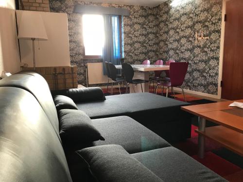 a living room with couches and a table with chairs at Apartments Ålholmvej in Copenhagen