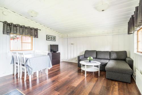 a living room with a couch and a table at First Camp Frösön-Östersund in Frösö