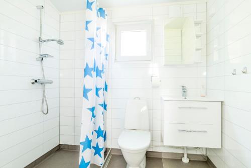 a white bathroom with a toilet and a sink at First Camp Frösön-Östersund in Frösö
