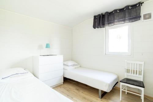 a bedroom with two beds and a window at First Camp Frösön-Östersund in Frösö