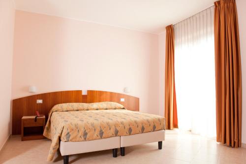 Postel nebo postele na pokoji v ubytování Hotel Meridiano