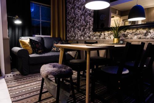 a living room with a table and chairs and a couch at Apartment Levi Star 1204 in Levi