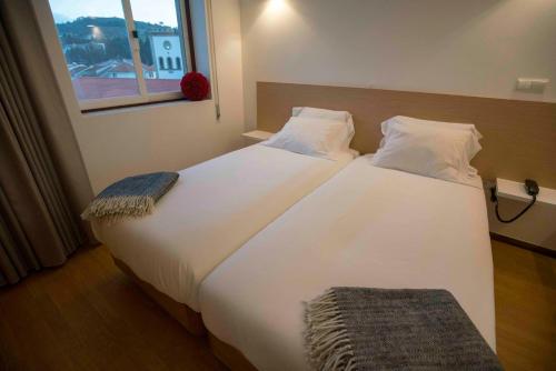 Katil atau katil-katil dalam bilik di Baixa Hotel