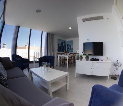 a living room with a couch and a tv at Life Apartments Alberto Lista in Seville