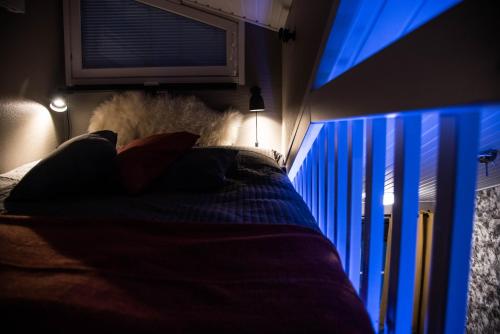 a bedroom with a bed and a window with blue lights at Apartment Levi Star 1204 in Levi