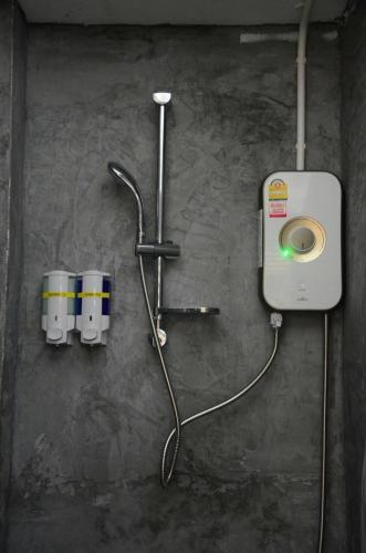 a shower with a hose hooked up to a machine at Best Stay Hostel At Lanta in Ko Lanta