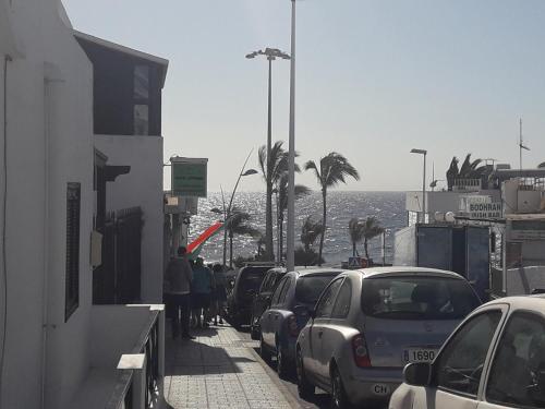 a street with cars parked on the side of the road at VILOTE Lanzarote in Tías