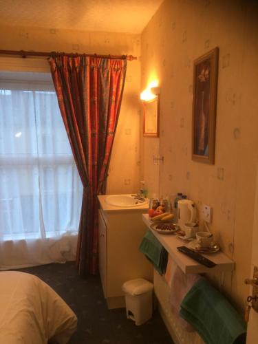 a small bathroom with a sink and a sink at Sheehans On Main Street in Kenmare