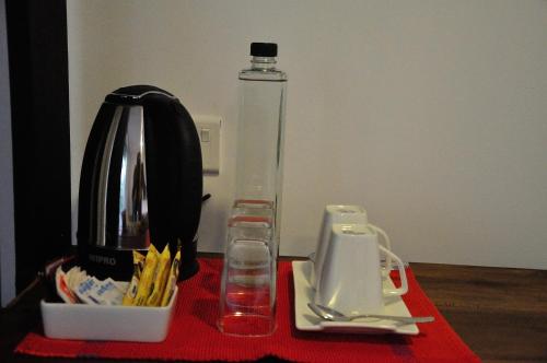 a red table with a blender and a glass bottle at The Backwaters Lodge in Wilpattu