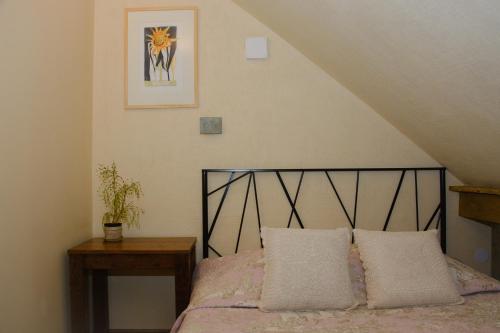 a bedroom with a bed with two pillows on it at Gallery Guest Rooms in Kernavė