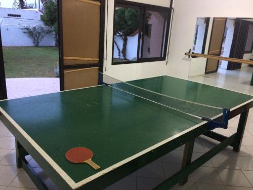 a ping pong table with a paddle on top of it at Cabanon Pied Dans L'eau in Mansouria
