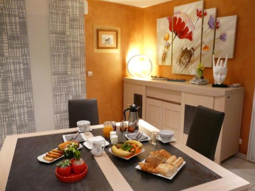 a dining room table with food on it at Chambre d'hôtes Le Pot au Lait in Villaines-la-Juhel